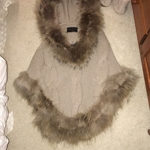 fox fur-lined wool cape. Classy to say the least.